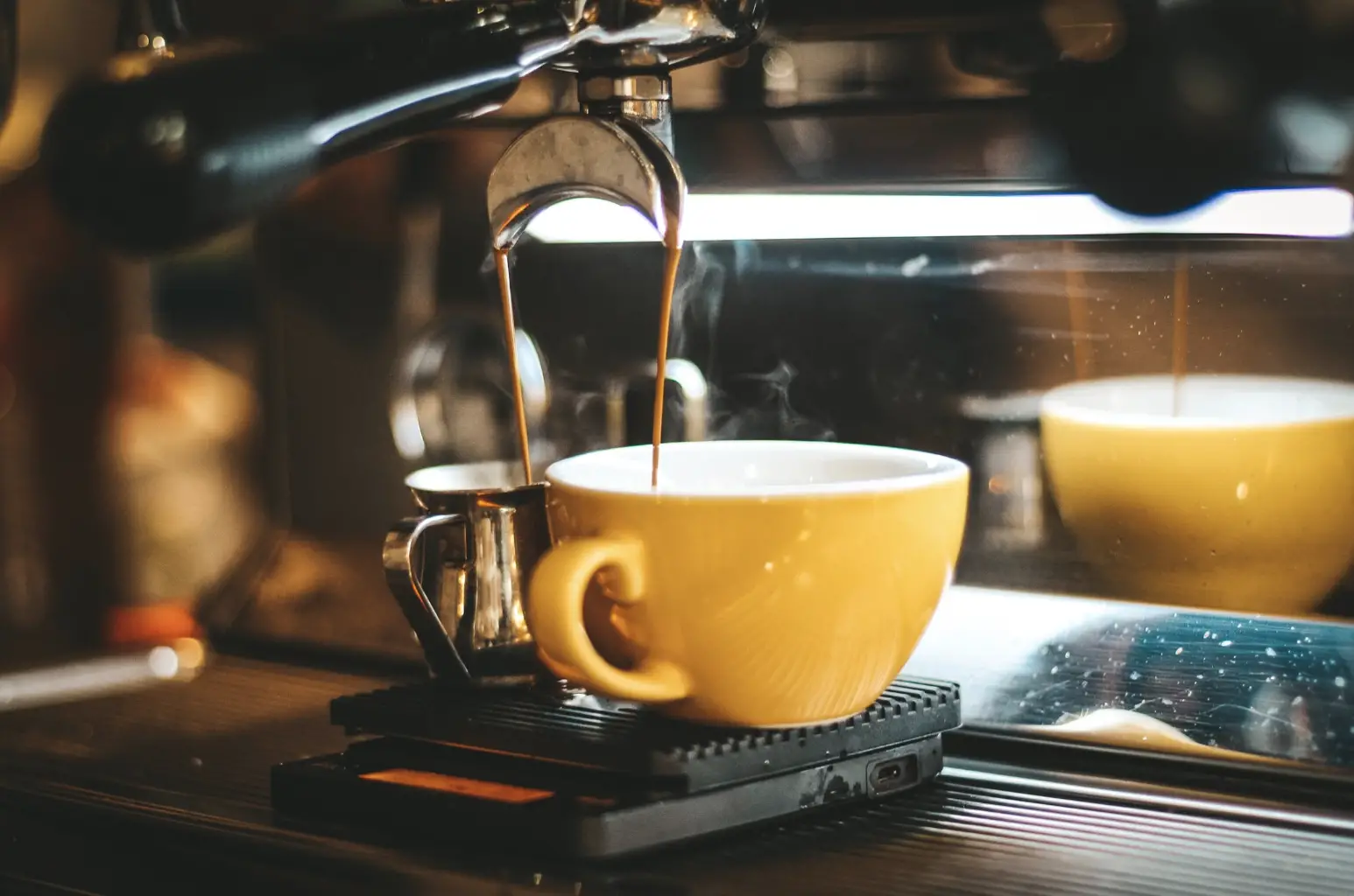 espresso machine dispensing in two mugs